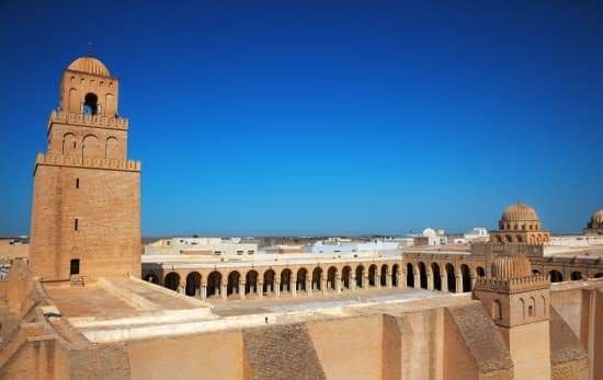 The Great Mosque of Kairouan, inner courtyard and minaret under blue sky